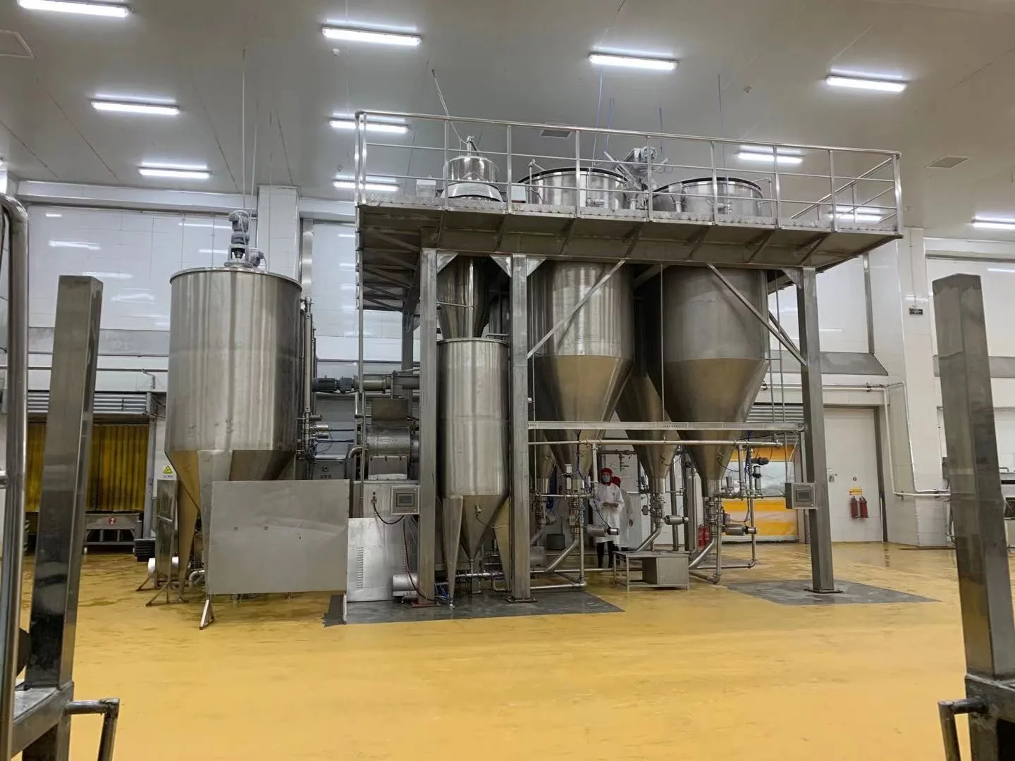 Stainless soaking and slurry tanks in a food-grade grain processing hall