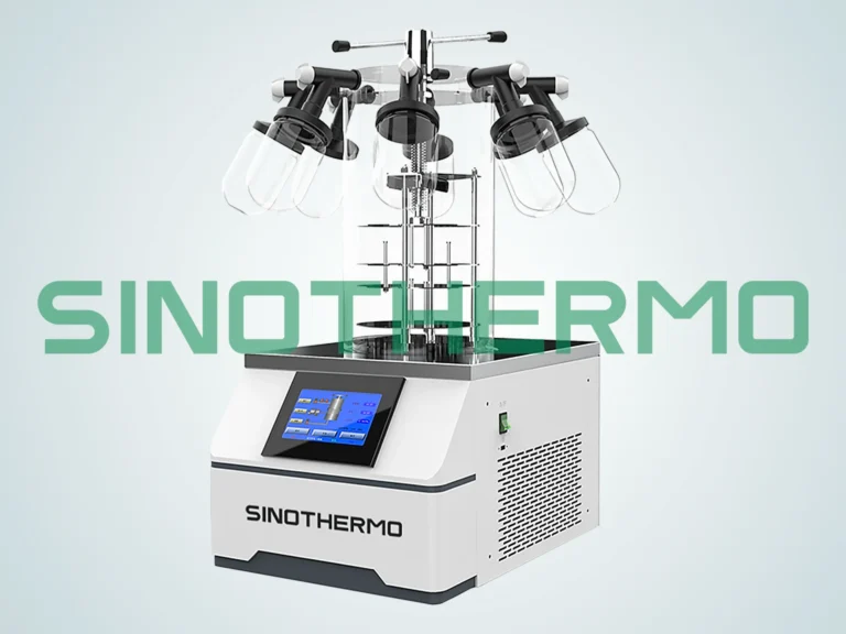 A Benchtop Freeze Dryer with several clear drying flasks attached to manifold, featuring a digital control panel and the 'SIONTHERMO' branding on the front, set against a plain grey background.