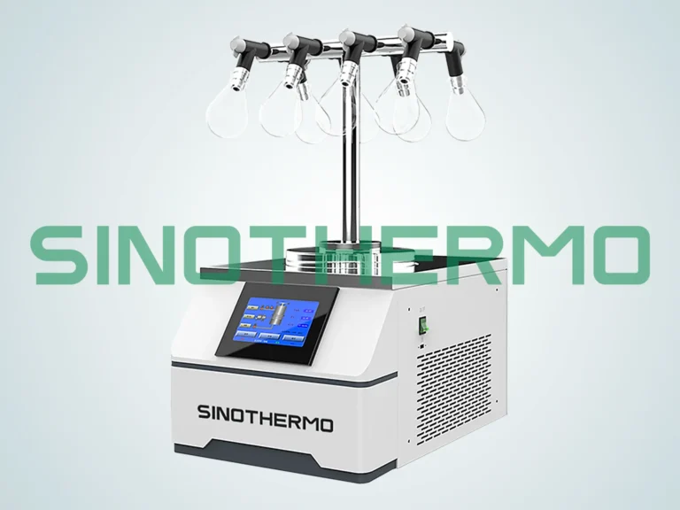 A modern Benchtop Freeze Dryer by SINOTHERMO with a digital interface, multiple drying flasks attached on top, set against a clear, grey background.