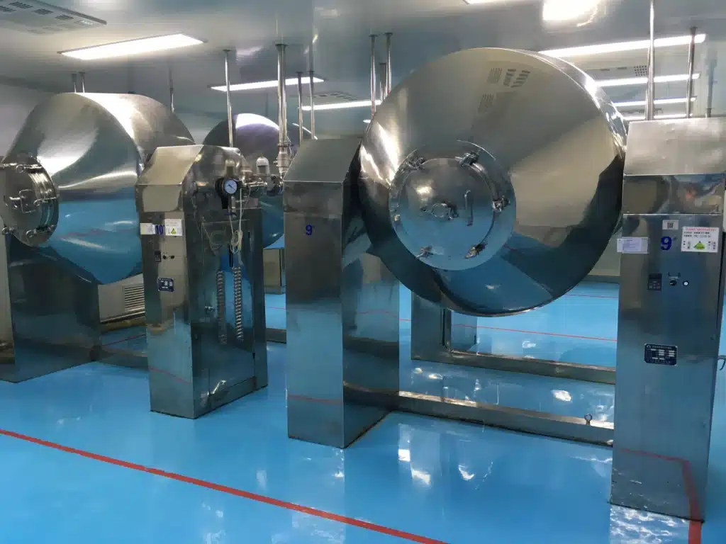 Industrial double cone dryers in a manufacturing facility, showcasing their stainless steel construction and advanced design for efficient drying processes.
